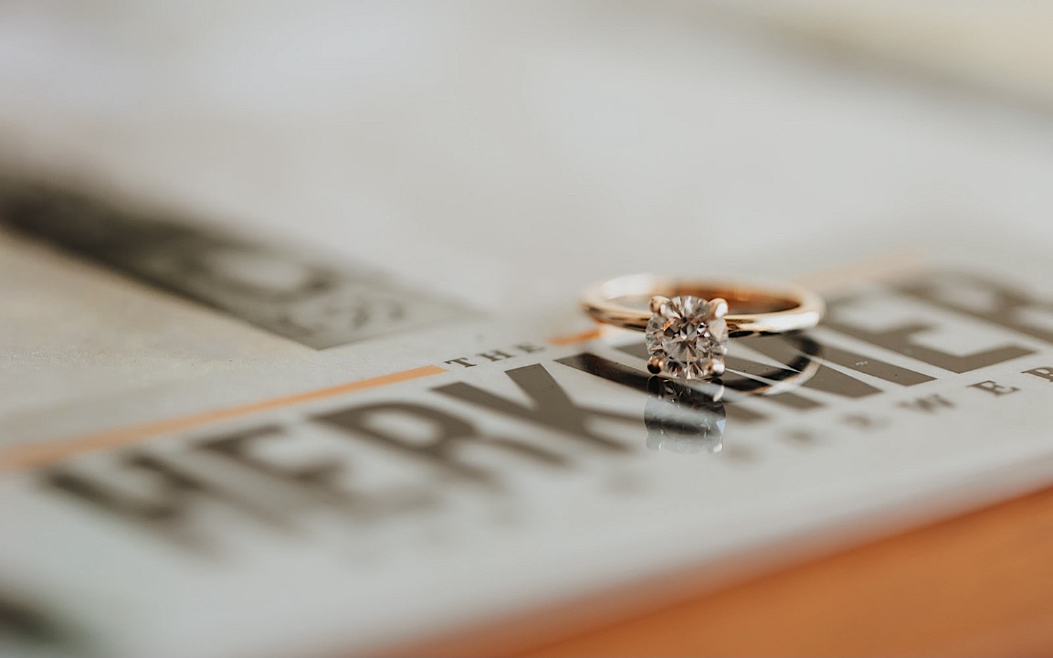 Detail photo of an engagement ring resting on a menu for a brewery.