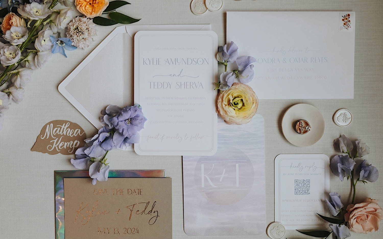 A wedding day flatlay consisting of flowers, wedding invites, and other decorations.