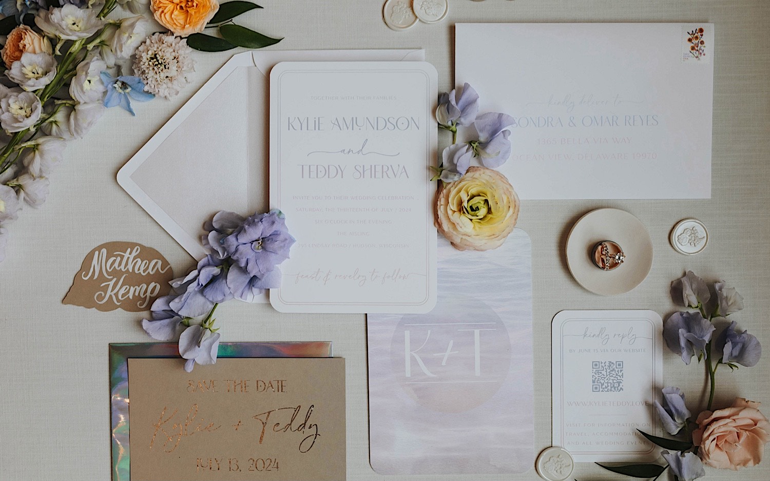 A wedding day flatlay consisting of flowers, wedding invites, and other decorations. A wedding day flatlay consisting of flowers, wedding invites, and other decorations.