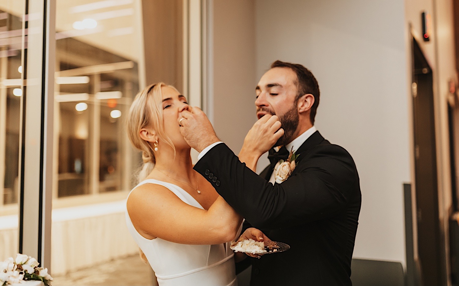 At a wedding reception in the La Crosse Center a bride and groom feed each other a piece of cake