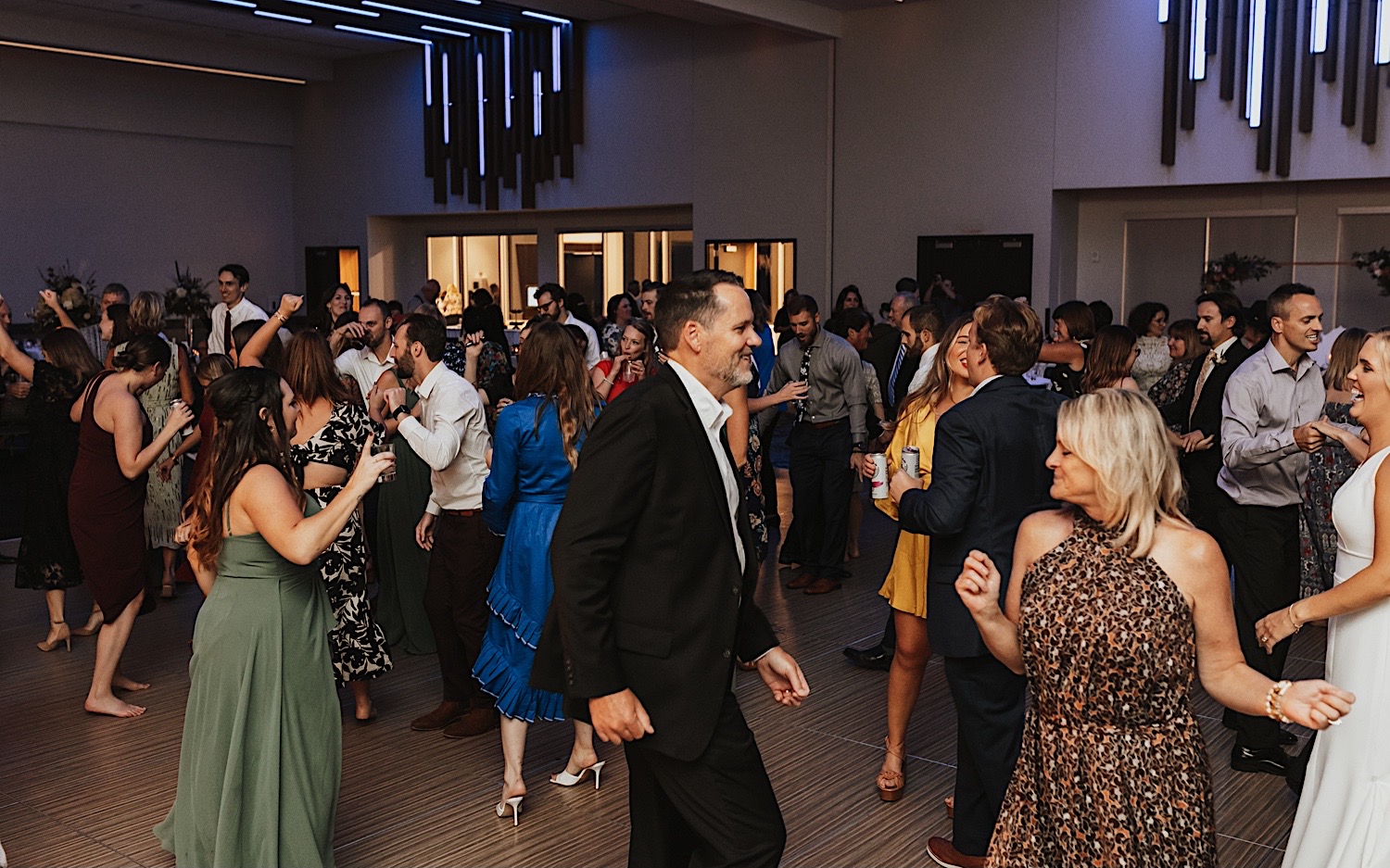 Guests of a wedding reception at the La Crosse Center pack the dance floor