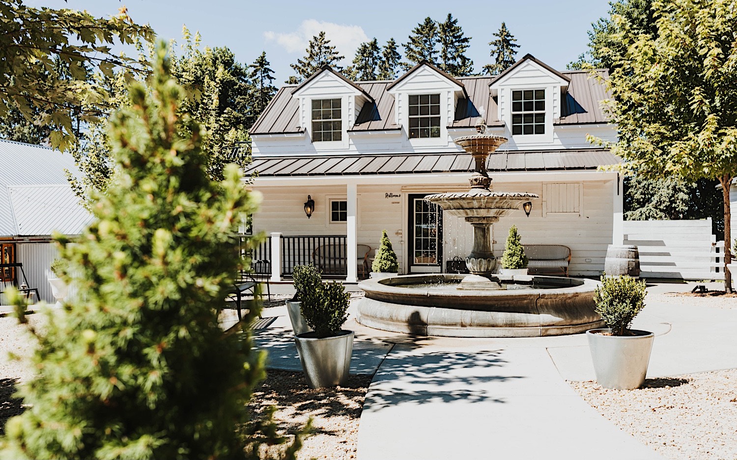 A fountain sits in the center of some of the buildings that make up the wedding venue Legacy Hill Farms in Minnesota