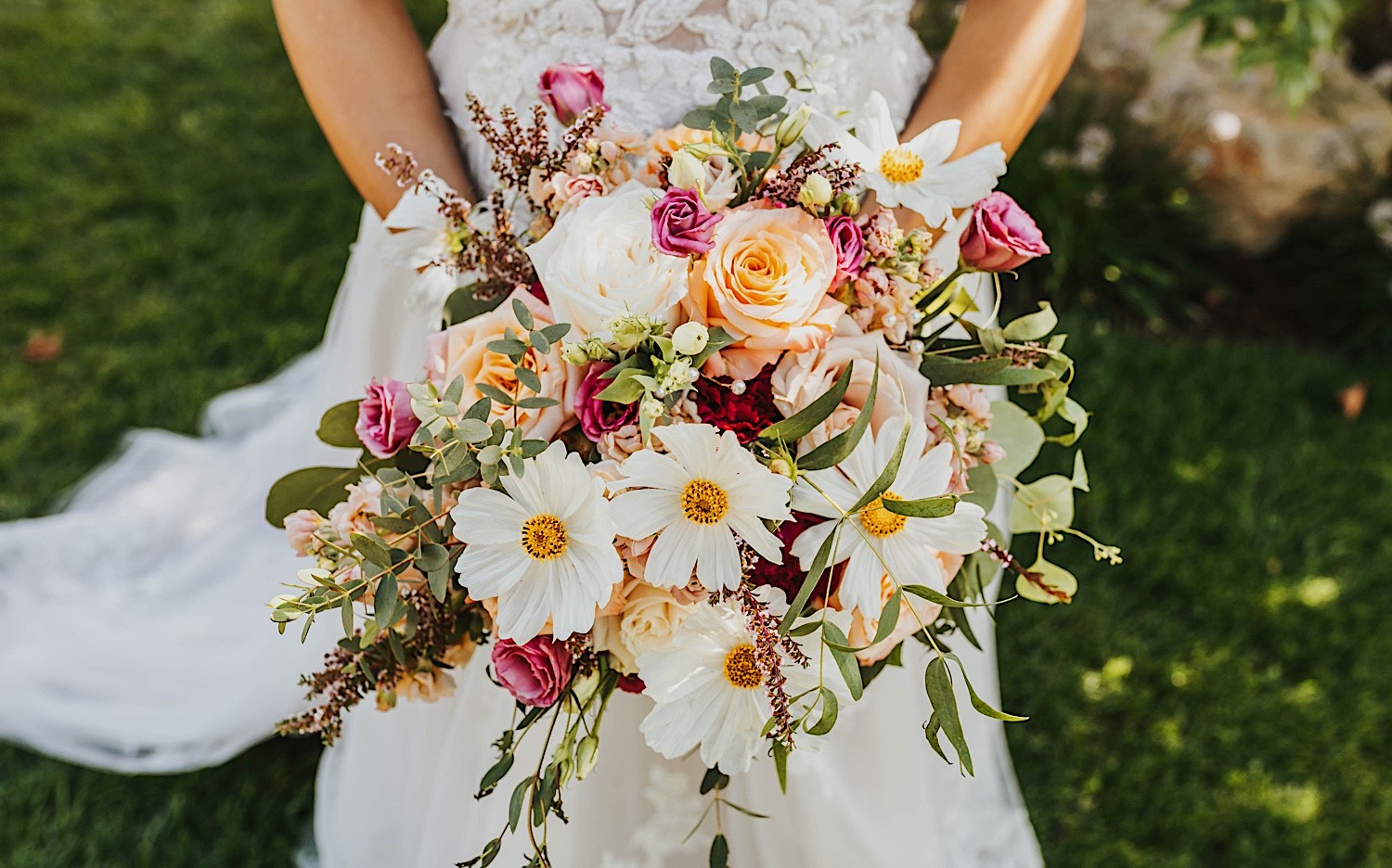 Close up photo of a flower bouquet being held by a bride