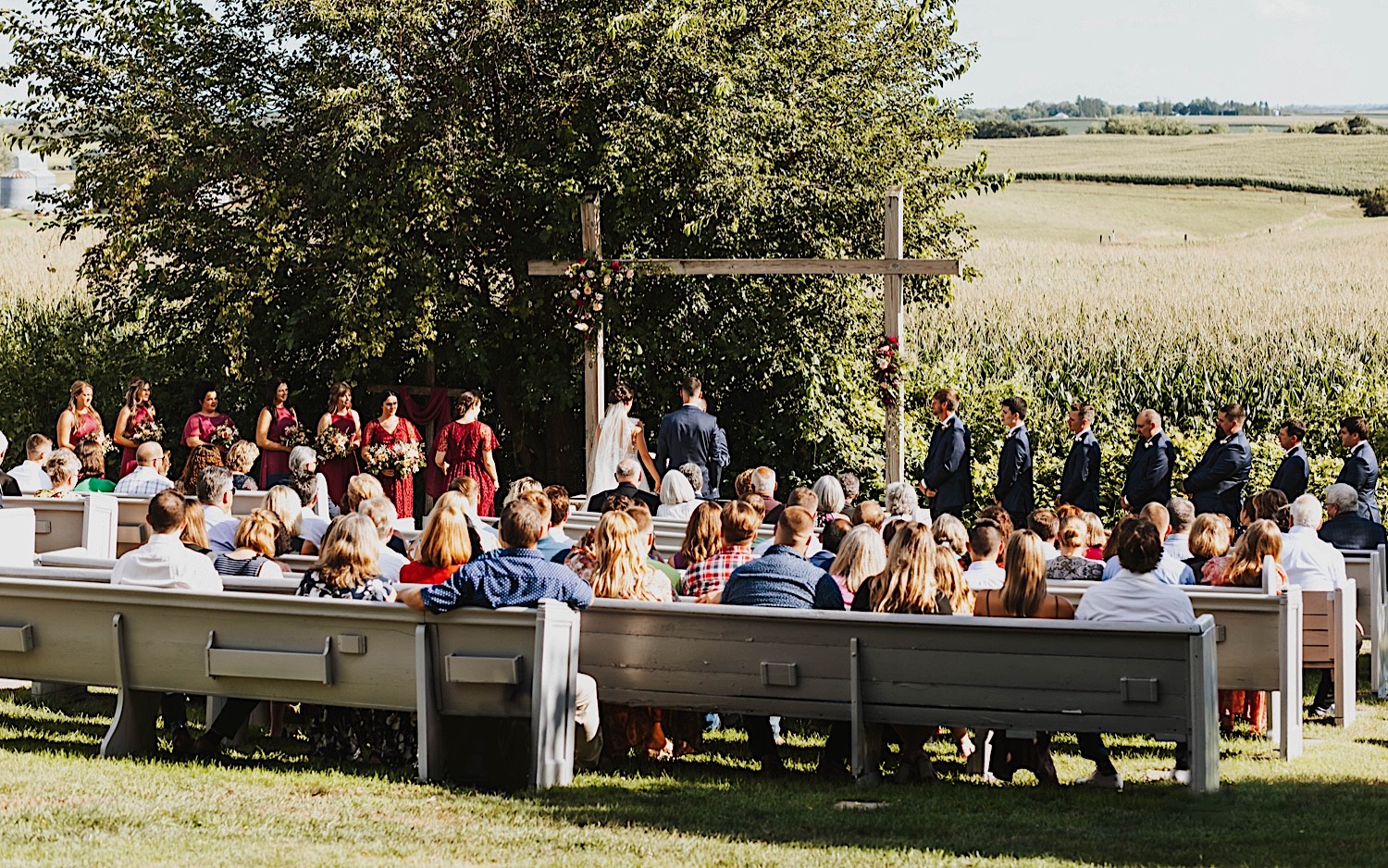 An outdoor wedding ceremony takes place at the venue Legacy Hill Farm in Minnesota