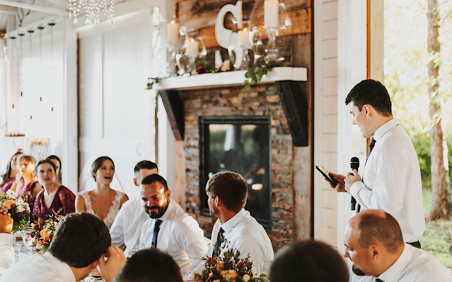 A groomsman gives a speech during a wedding reception at Legacy Hill Farm's indoor reception space A groomsman gives a speech during a wedding reception at Legacy Hill Farm's indoor reception space