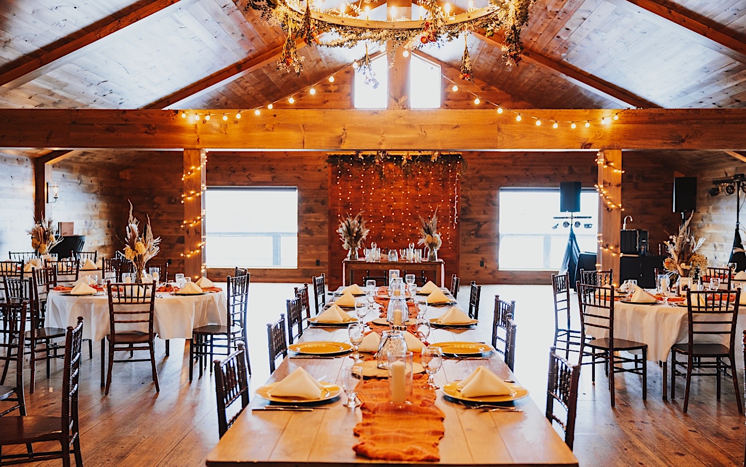 The wooden interior of Lake Bomoseen Lodge in Vermont set up and decorated for a wedding reception