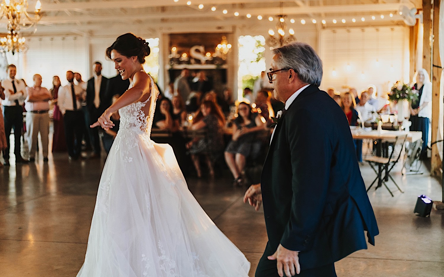 A bride dances with her father during her indoor wedding reception at Legacy Hill Farm