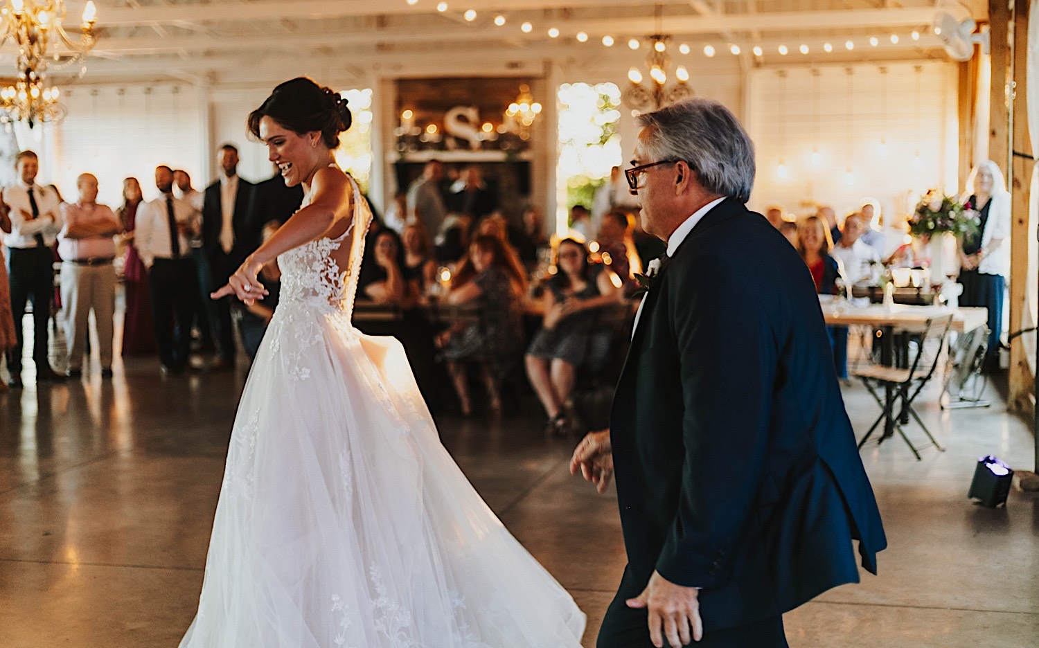 A bride dances with her father during her indoor wedding reception at Legacy Hill Farm A bride dances with her father during her indoor wedding reception at Legacy Hill Farm
