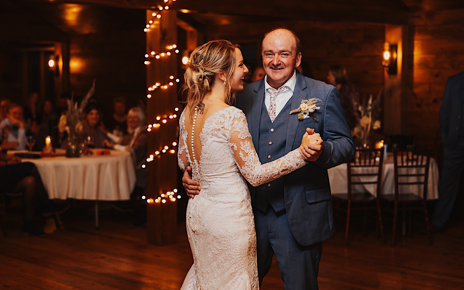 A bride and her father share their first dance together during the bride's indoor wedding reception at Lake Bomoseen Lodge in Vermont